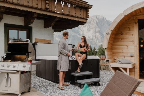 a man and a woman sitting on top of a stove at Mountain Residence Riesgut - Sound of Music in Werfen