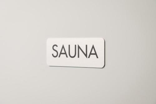 a sign with the word sauna on it at Guestly Homes - Cozy Studio in Luleå