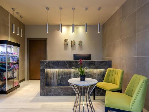 a lobby with a table and two chairs at Movenpick Living Istanbul West in Istanbul