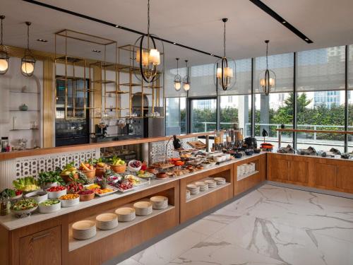 a buffet line with a lot of food on display at Movenpick Living Istanbul West in Istanbul