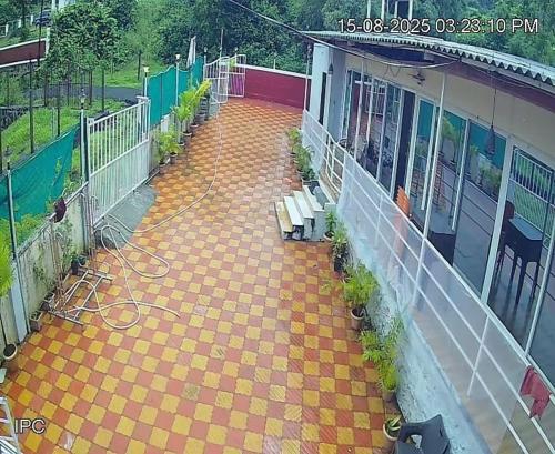 Una vista aérea de un patio con bancos en un edificio. en fm cottage, en Murud