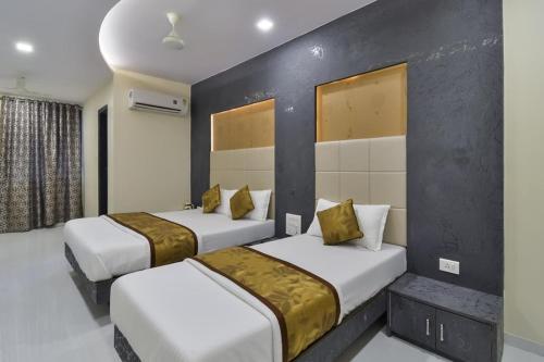 two beds in a hotel room with at Hotel Aroma- Dadar in Mumbai