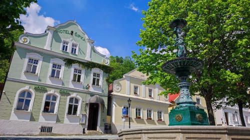 a building with a statue in front of a building at Apartmán Dva na moto in Příbor