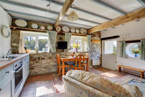 a kitchen with a couch and a table in a room at The Stables in Whitland