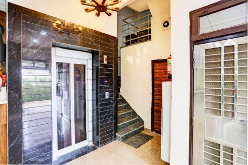 a door leading into a home with a brick wall at Hotel O Rajhans in Gurgaon
