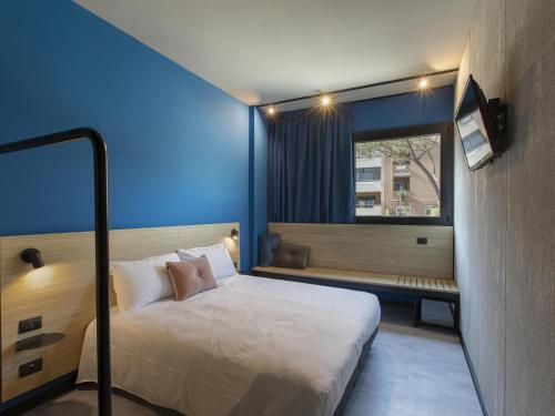 Una cama o camas en una habitación de Ibis Styles Roma Aurelia