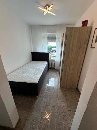 a bedroom with a bed and a sliding door at Ferienwohnung Forstblick in Kranenburg