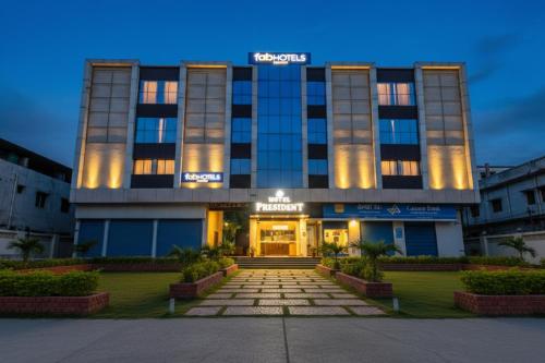a building with a lit up front of it at FabHotel Prime President- Bhopal Railway Station in Bhopal