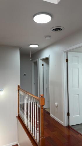a hallway with a staircase and a white ceiling at Cozy & Private Retreat Near Atlantic City! in Galloway