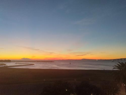 a sunset on a beach with the ocean at Mare Magnum in Castellammare di Stabia