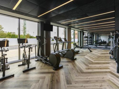 a gym with treadmills and elliptical machines at Novotel Cambridge North in Cambridge