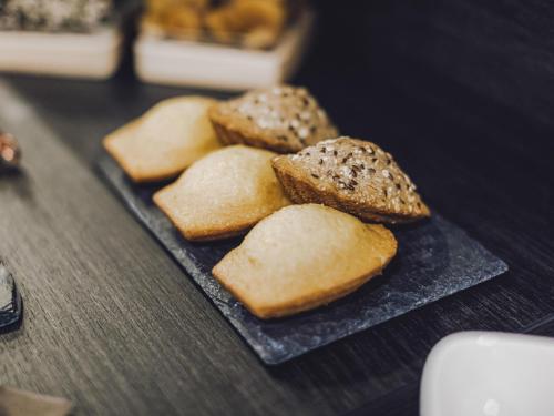 four pieces of bread on a plate on a table at ibis Styles Contres-Cheverny in Le Controis En Sologne