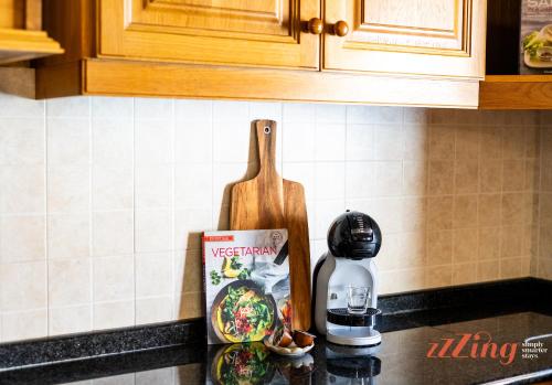 a kitchen counter with a cutting board and a bottle of water at Gozo Farmhouse Escape with Rustic Charm & Pool in Sannat