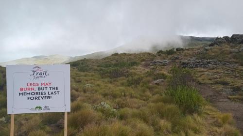a sign on the side of a hill with a mountain at Juniper Park Resort in Nyahururu