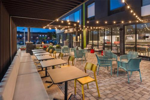 a restaurant with tables and chairs and lights at Home2 Suites By Hilton Reynoldsburg Columbus East in Columbus