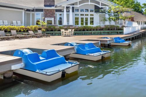 a pool with blue lounge chairs in the water at Hilton Vacation Club Beachwoods Kitty Hawk in Kitty Hawk