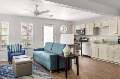 a living room with a blue couch and a table at Hilton Vacation Club Beachwoods Kitty Hawk in Kitty Hawk