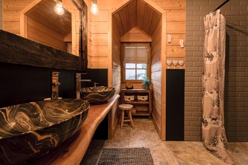 a bathroom with a large tub and a sink at Chata Dwie Doliny in Muszyna