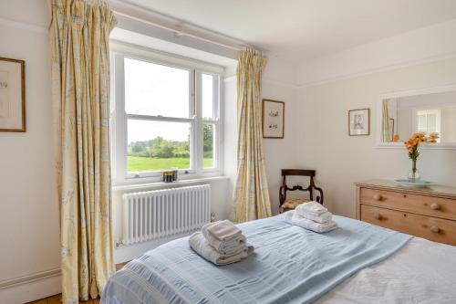 a bedroom with a bed with towels on it at Lodge Farm Cottage in Sudbourne
