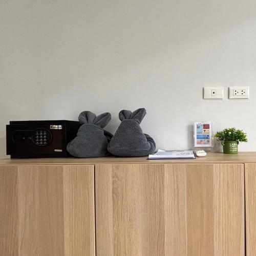two stuffed rabbits sitting on top of a cabinet at Xen Pool Access in Chalong 