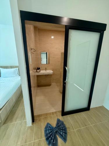 a bedroom with a sliding door leading to a bathroom at Oh my cup khao sok resort in Khao Sok National Park