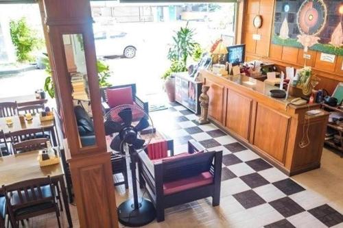 a room with a restaurant with a table and chairs at The Nice Patong Hotel in Ban Nong Chaeng