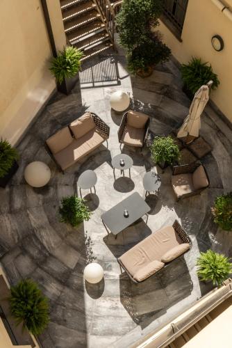 an overhead view of a patio with furniture and tables at Hotel Royal Falcone in Monza