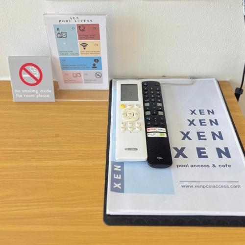 a remote control on top of a box on a table at Xen Pool Access in Chalong 