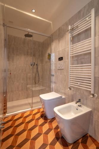 a bathroom with a toilet and a sink and a shower at Casale Magrini Affittacamere in Fiamenga