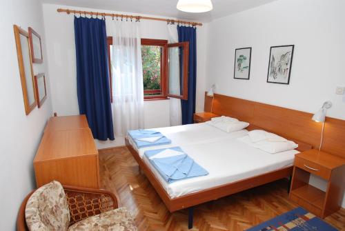 a bedroom with a large bed and a window at Holiday Home Olive Tree in Budva