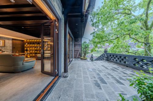 an external view of a house with a patio at YiQuan RIVERVIEW B&B in Fenghuang