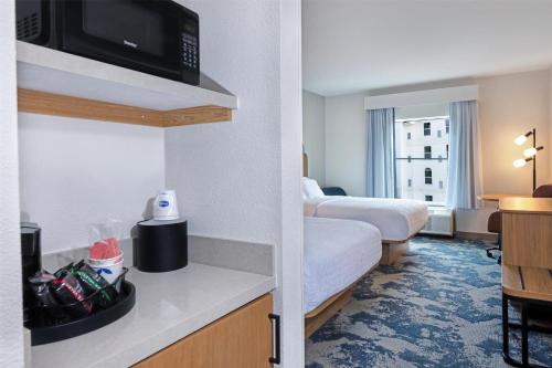 a hotel room with two beds and a tv at Hampton Inn Lawrenceville Duluth in Lawrenceville
