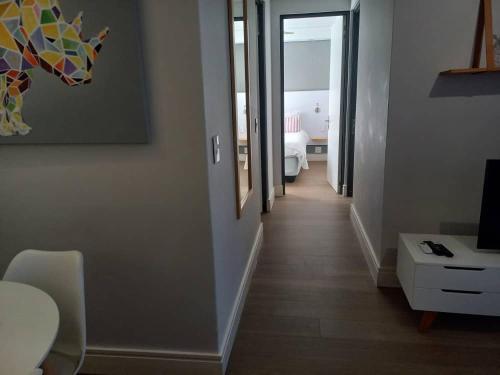 a hallway leading to a living room with a television at iKON Self-Catering in Windhoek