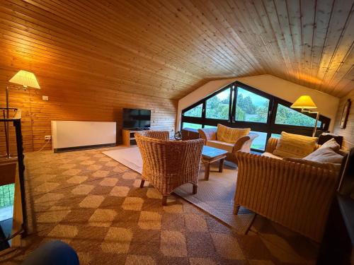 a living room with a couch and a table and chairs at Landhaus Margarete im Feriendorf Reichenbach in Nesselwang