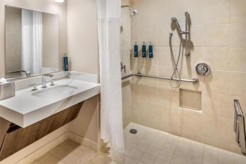 a bathroom with a sink and a shower at Hilton Grand Vacations Club Kohala Suites Waikoloa in Waikoloa