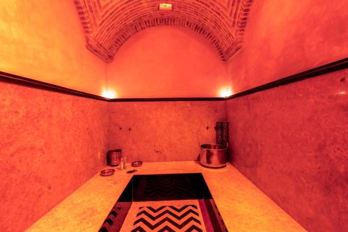 a small room with a table and a ceiling at Riad AL-Ghazlan Hamam & Spa in Marrakech