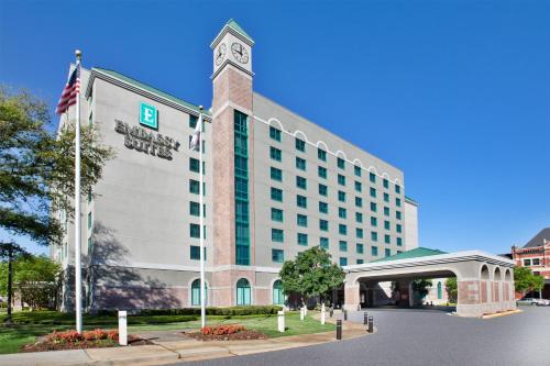 a hotel with a clock tower on top of a building at Embassy Suites Montgomery - Hotel & Conference Center in Montgomery