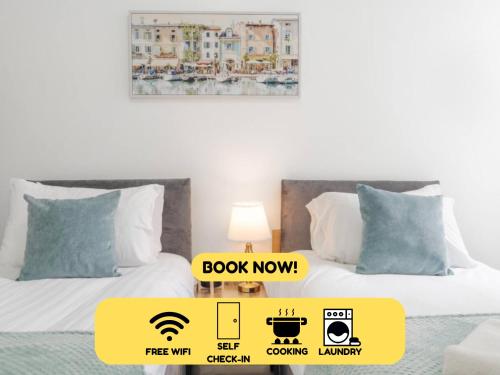 two beds with a sign that says book now in a bedroom at Newly Renovated 4BR House with lots of amenities in Liverpool