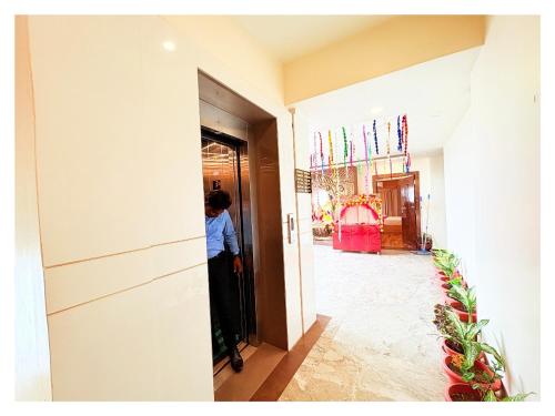 a person standing in a hallway of a room at Sea View Hotel Durene Beach Resort Near Sea Beach And Jagannath Temple - Fully Air Condition with All Luxury Rooms With Attached-Balcony Free Wifi & Lift Facilities# Boutique Services - A Top Rated Hotel IN Puri in Puri