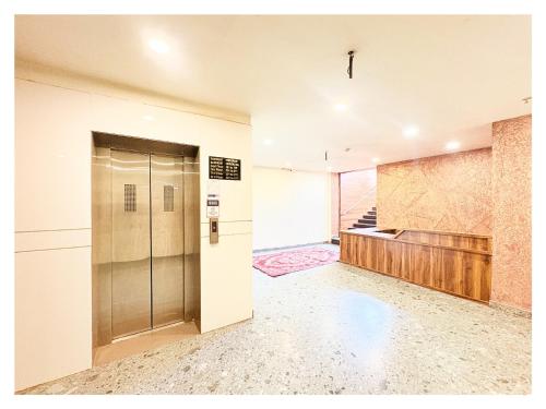 an empty lobby with a elevator and a door at Sea View Hotel Durene Beach Resort Near Sea Beach And Jagannath Temple - Fully Air Condition with All Luxury Rooms With Attached-Balcony Free Wifi & Lift Facilities# Boutique Services - A Top Rated Hotel IN Puri in Puri