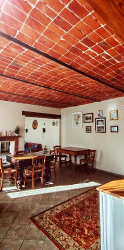a living room with wooden tables and a rug at B&B Lanterna delle Fate in Asti