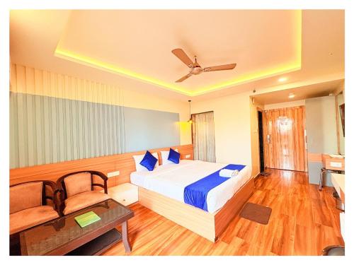 a bedroom with a bed and a table and a ceiling at Sea View Hotel Durene Beach Resort Near Sea Beach And Jagannath Temple - Fully Air Condition with All Luxury Rooms With Attached-Balcony Free Wifi & Lift Facilities# Boutique Services - A Top Rated Hotel IN Puri in Puri