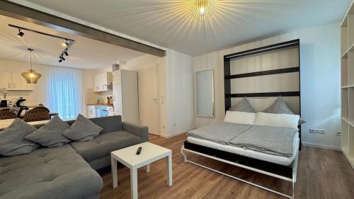a living room with a couch and a table at 2-Zimmer-Wohnung-Küche-Bad-Terrasse, Bahnhofsnähe in Mühlacker