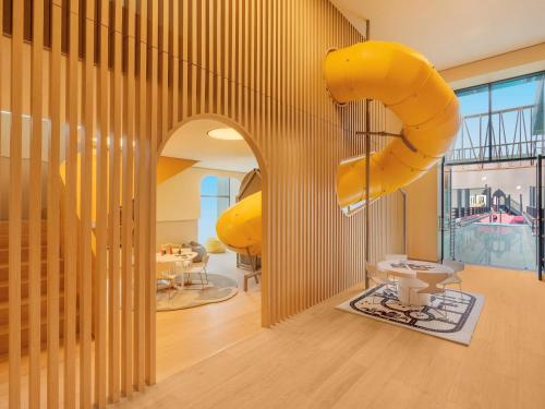 a room with a large yellow inflatable slide at Fairmont Ramla Serviced Residences in Riyadh
