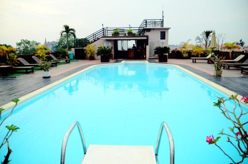 a large pool with blue water in a hotel at City River Hotel in Siem Reap