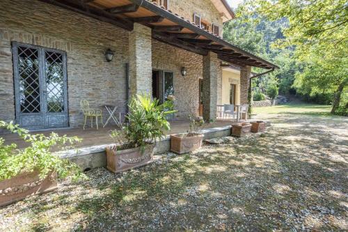 a patio of a house with a table and chairs at Villa Alexandra by MMega in Riomagno