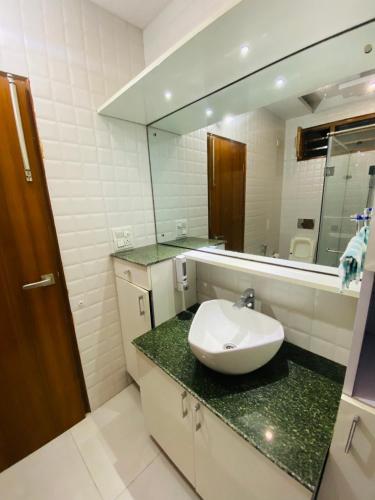 a bathroom with a sink and a mirror at 3BHK Stay Royal Villa in Mohali in Zirakpur