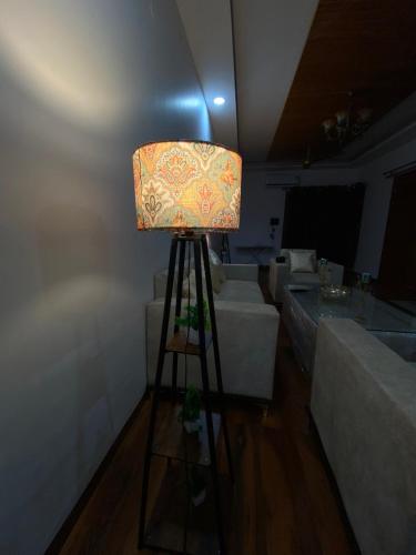 a lamp in the middle of a room with couches at 3BHK Stay Royal Villa in Mohali in Zirakpur
