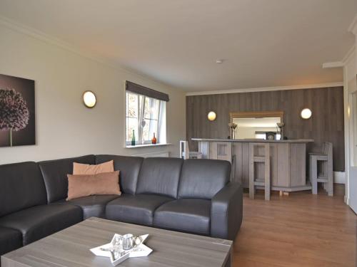 a living room with a couch and a kitchen at Villa with Sauna in Liesen in Hallenberg