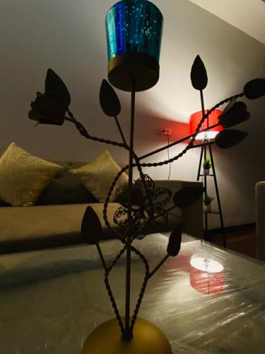 a room with a table with a vase with a plant at 3BHK Stay Royal Villa in Mohali in Zirakpur